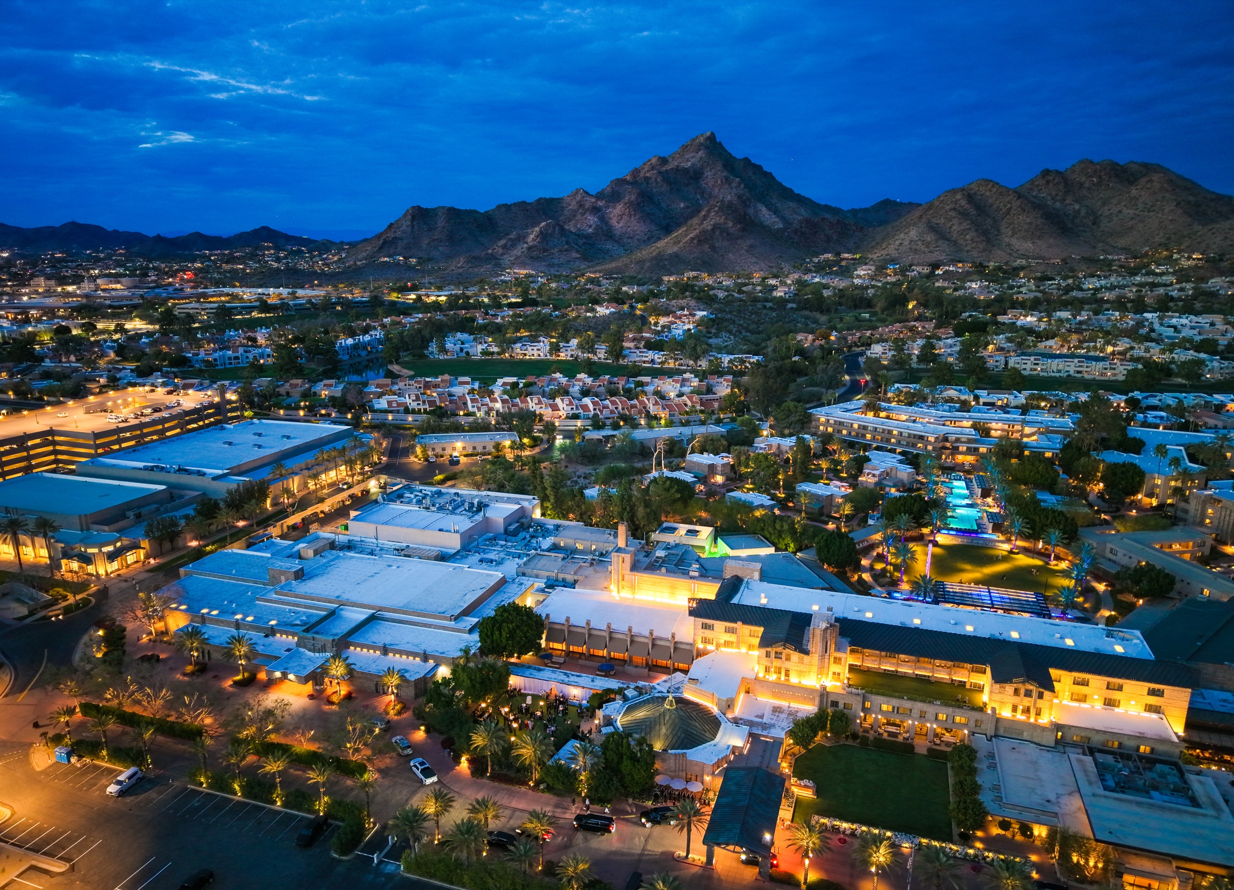 Aerial drone photography of Scottsdale Arizona resort district at twilight with mountains