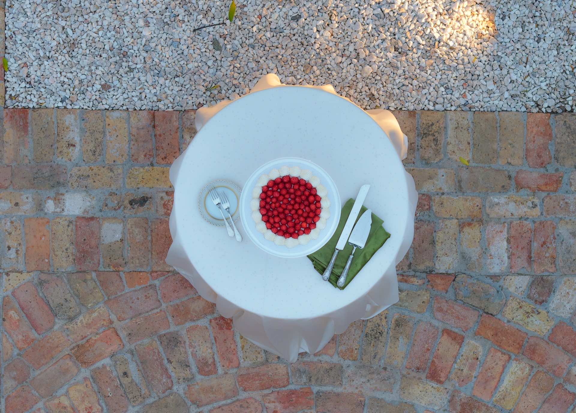 Overhead drone photography of elegant table setting at outdoor wedding reception
